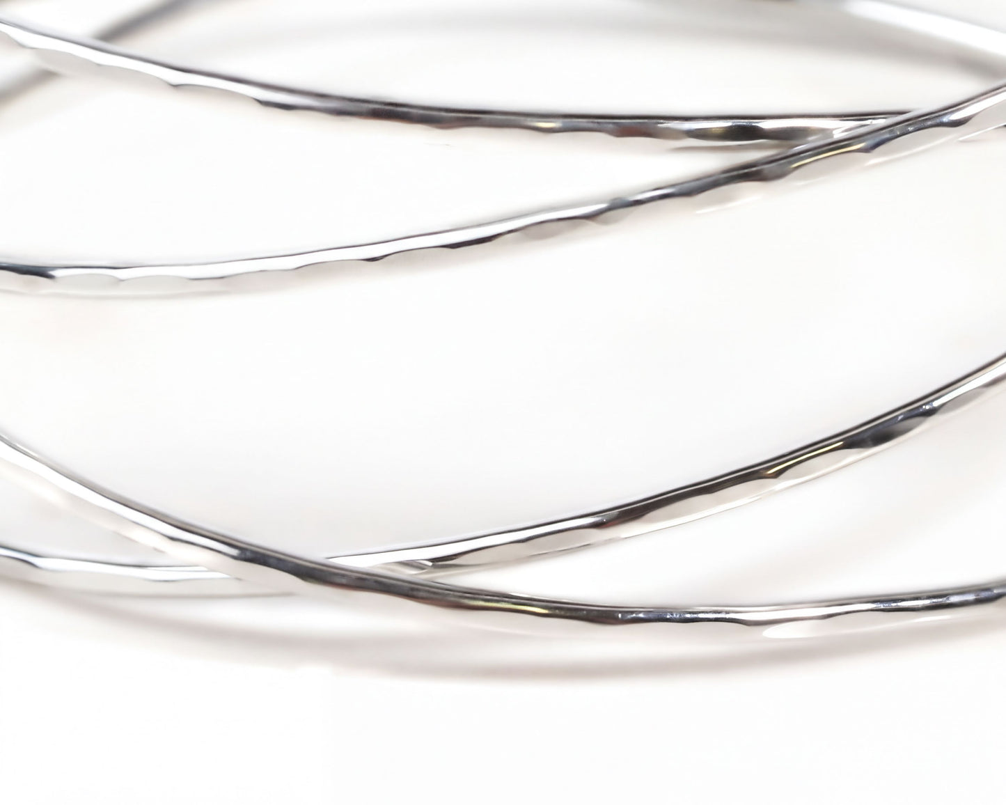 A close-up view of a silver bracelet with a textured, shiny appearance.