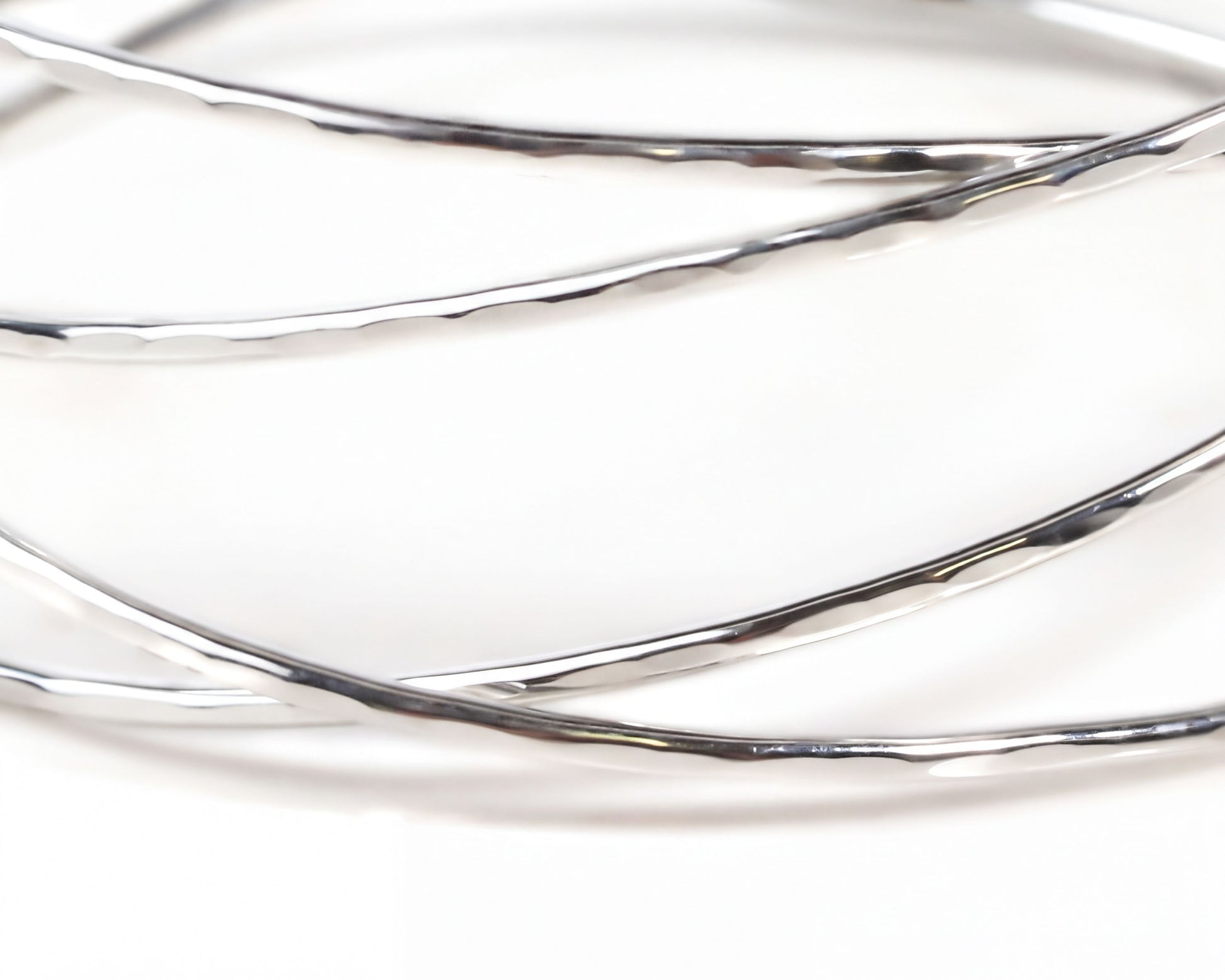 A close-up view of a silver bracelet with a textured, shiny appearance.