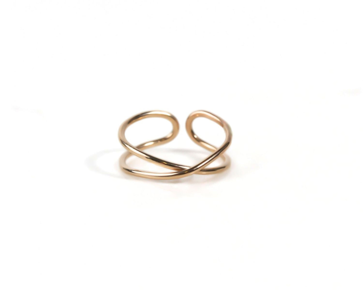 A gold-colored ring with a twisted, intertwined design.