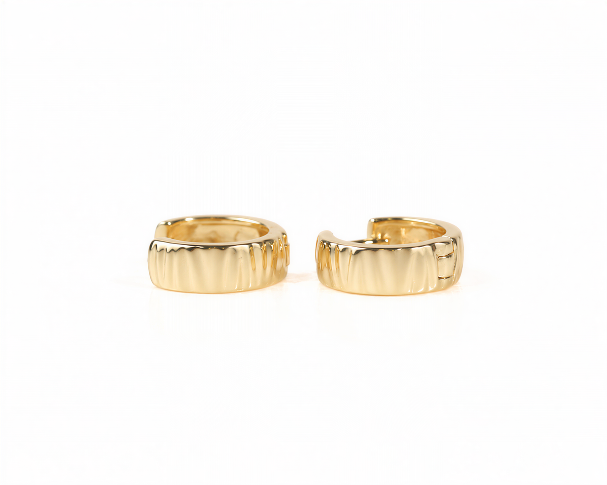 Two gold earrings with a textured design are shown against a white background.
