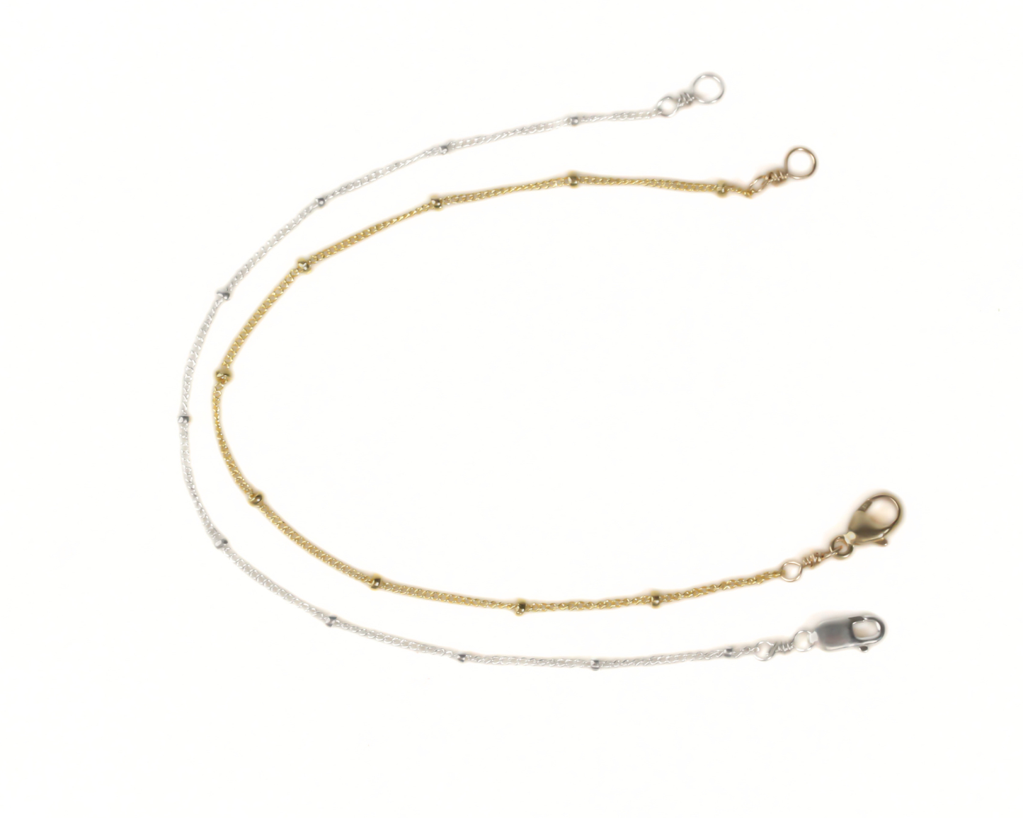 a pair of gold and silver chain necklaces with a clasp and a lock attached to the ends.