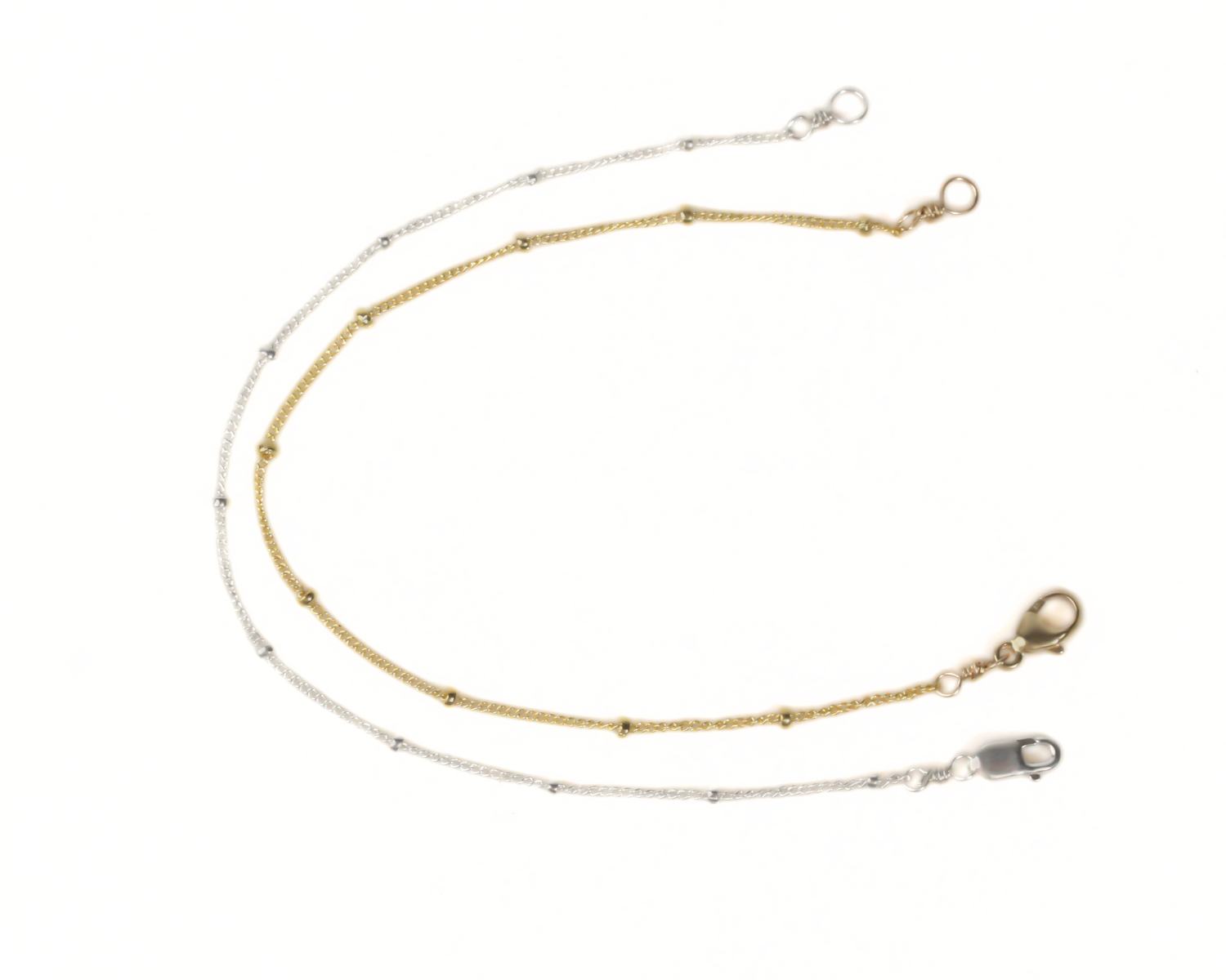 a pair of gold and silver chain necklaces with a clasp and a lock attached to the ends.