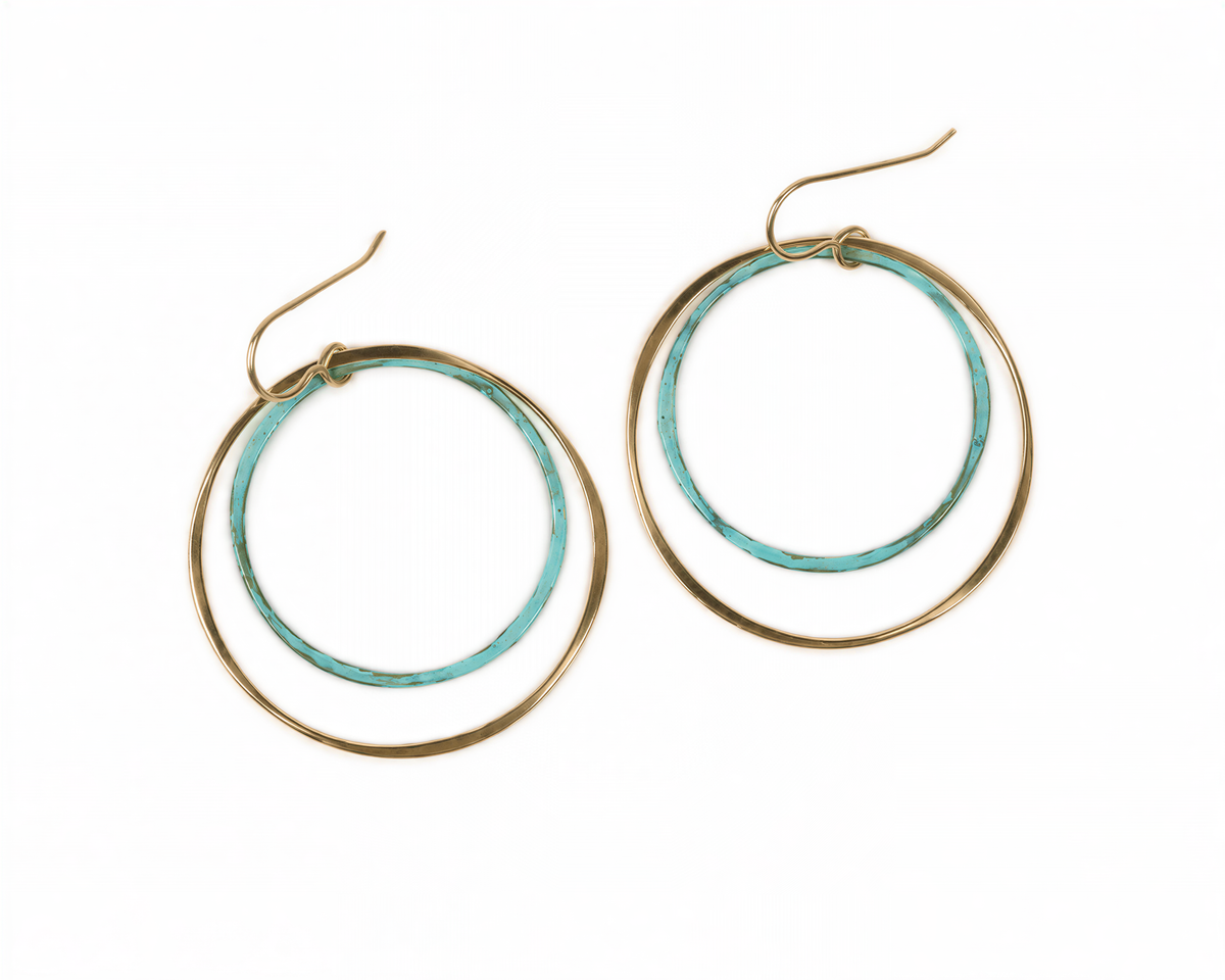 A pair of turquoise-colored hoop earrings with gold-colored metal frames.