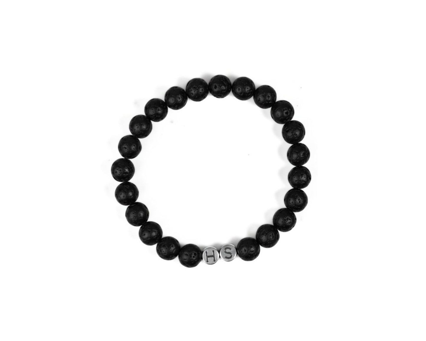 A black and white image of a bracelet made of black beads arranged in a circular pattern.