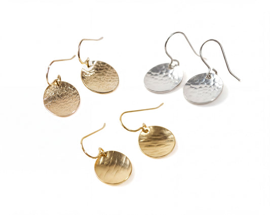 a collection of four earrings, each with a unique design and color. The earrings are arranged in a square formation, showcasing their intricate details and craftsmanship.