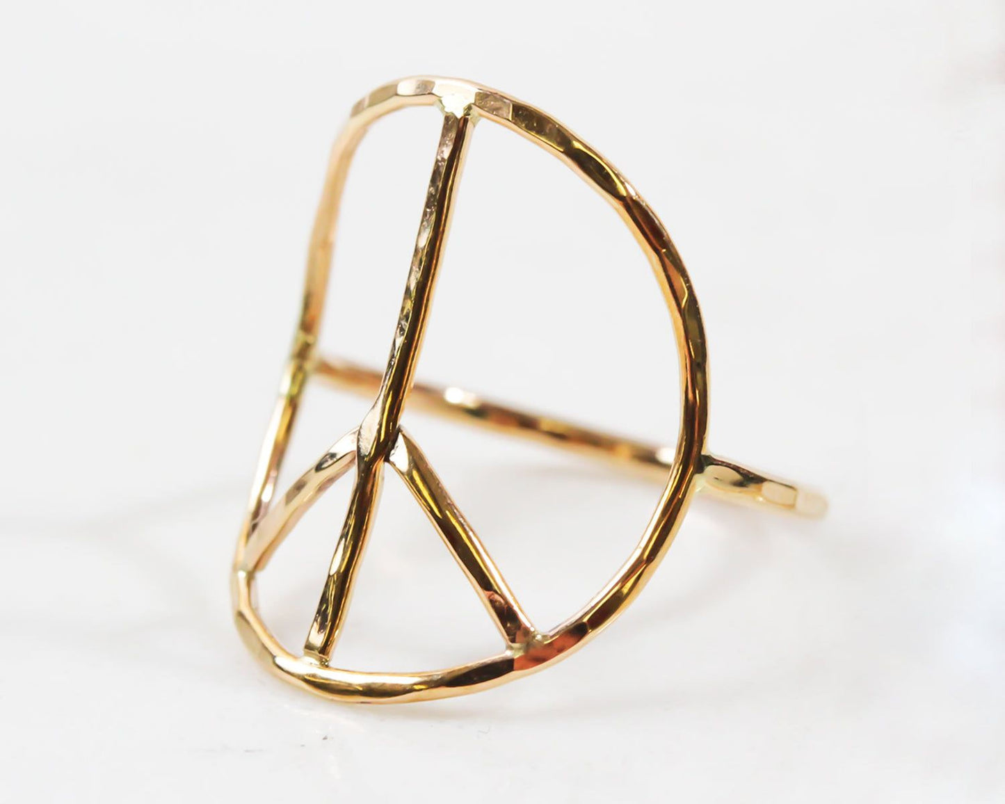 A gold ring in the shape of a peace sign.