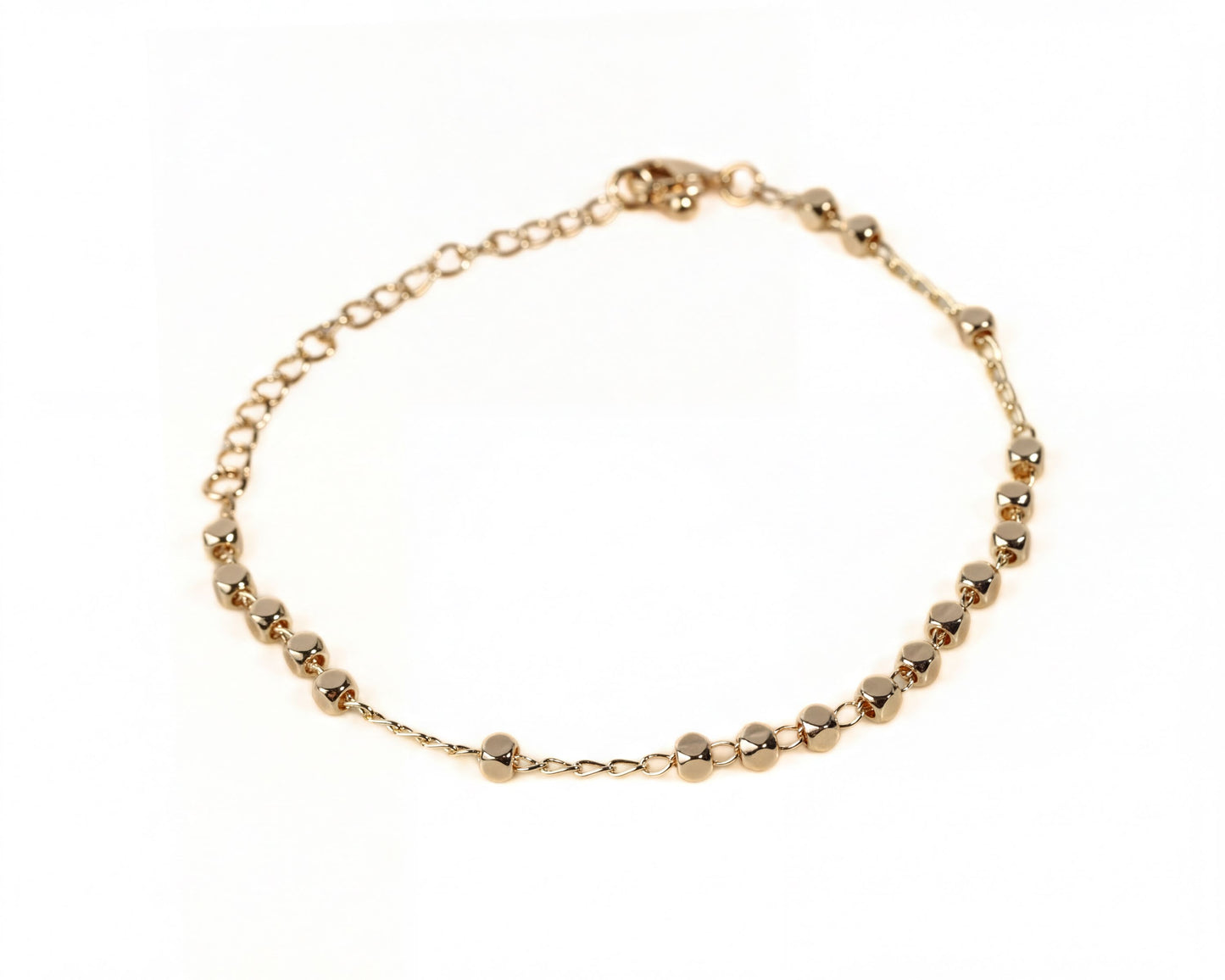 A gold-colored bracelet with a row of small, round beads on a white background.