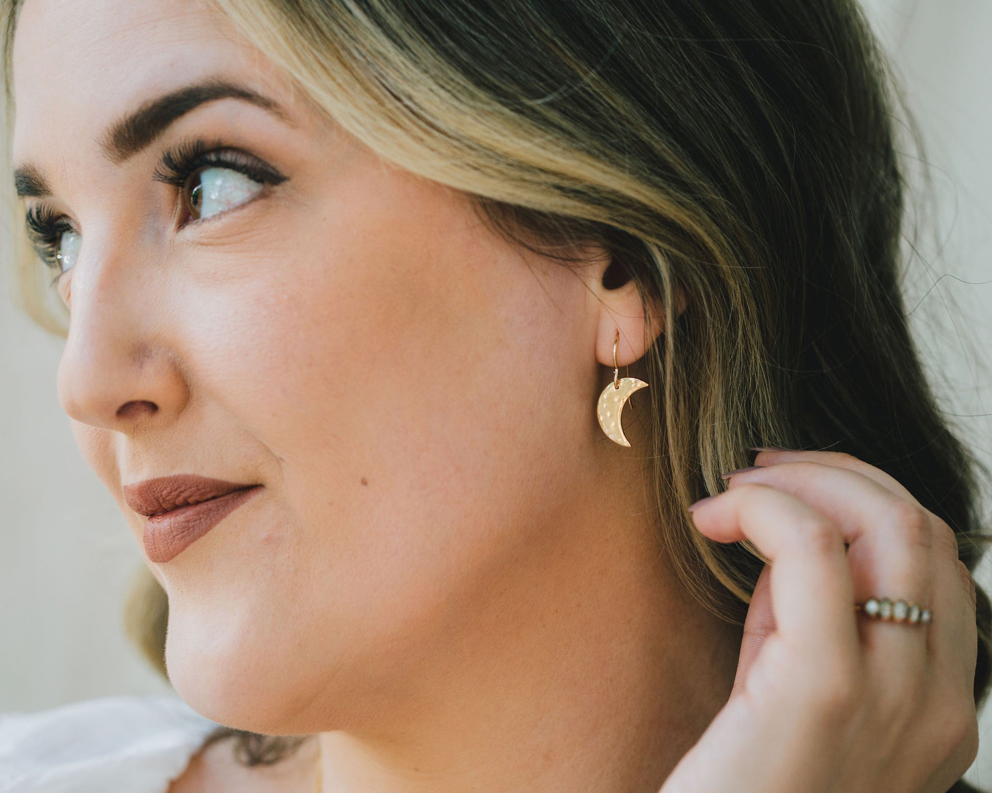 Model is wearing the 14 karat yellow gold filled version of our celestial sisterhood earrings. Handcrafted using elevated materials, choose from yellow gold or sterling silver. They are delicately hand hammered to mimic the surface of the moon.
