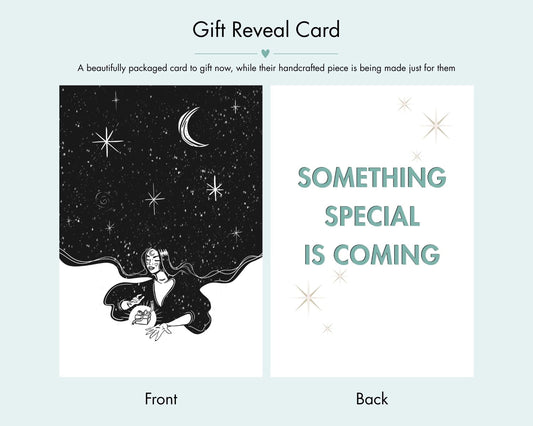 The image is a gift reveal card with a black and white illustration of a woman holding a crescent moon and stars. The card is presented in two different views: the front view shows the woman holding the crescent moon and stars, while the back view shows the same illustration without the woman. The text on the card announces that a beautifully packaged card is being made just for them, and it mentions that something special is coming.