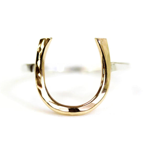 A gold-colored ring with a horseshoe-shaped cutout in the center.