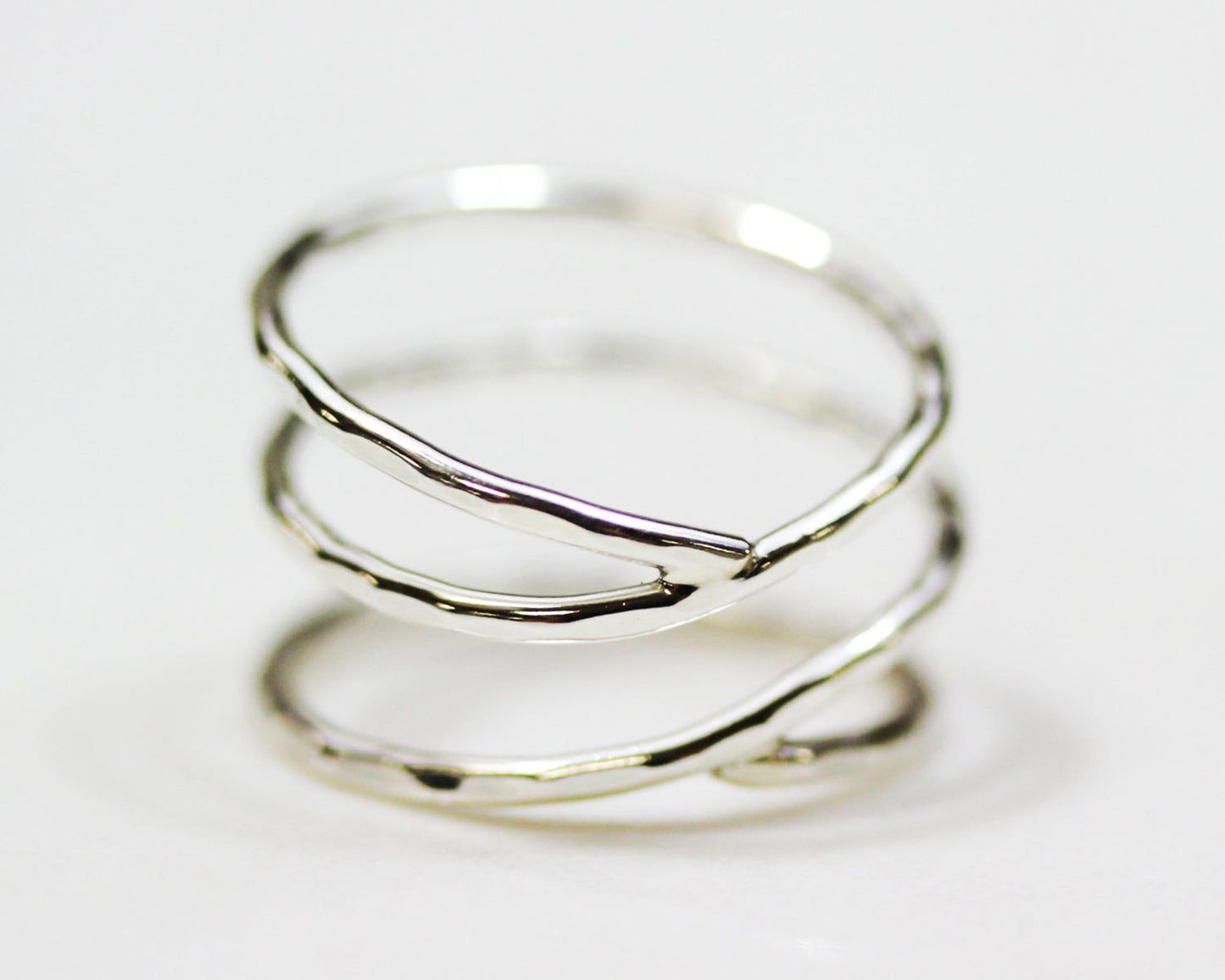 A silver ring with a unique, twisted design.