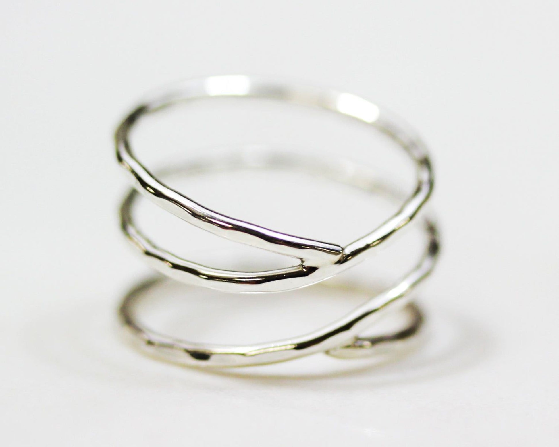 A silver ring with a unique, twisted design.