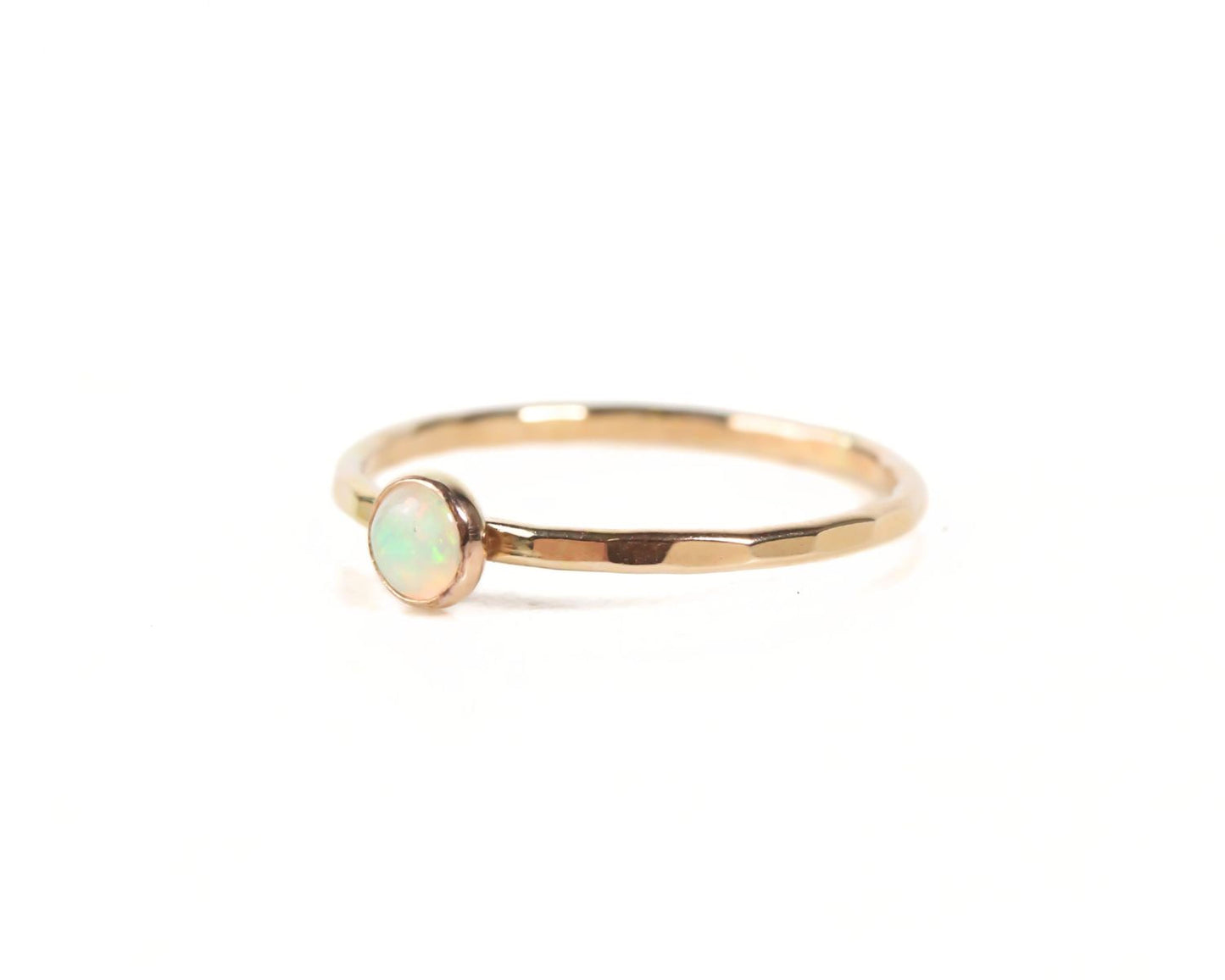 A gold ring with a small opal stone set in the center.