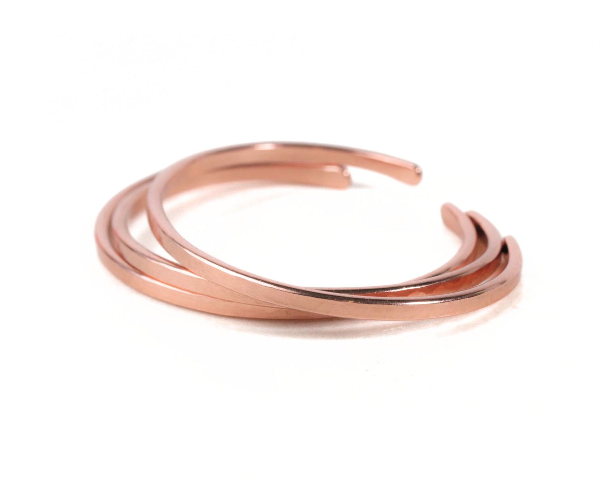 A copper-colored bracelet with multiple curved bands.