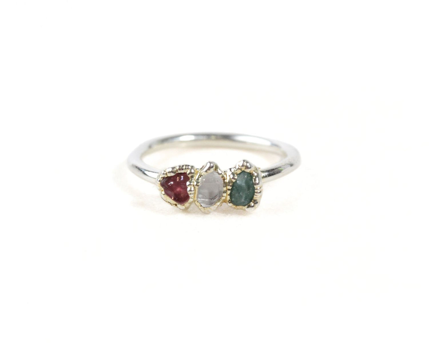 A silver ring with three gemstones set in it.
