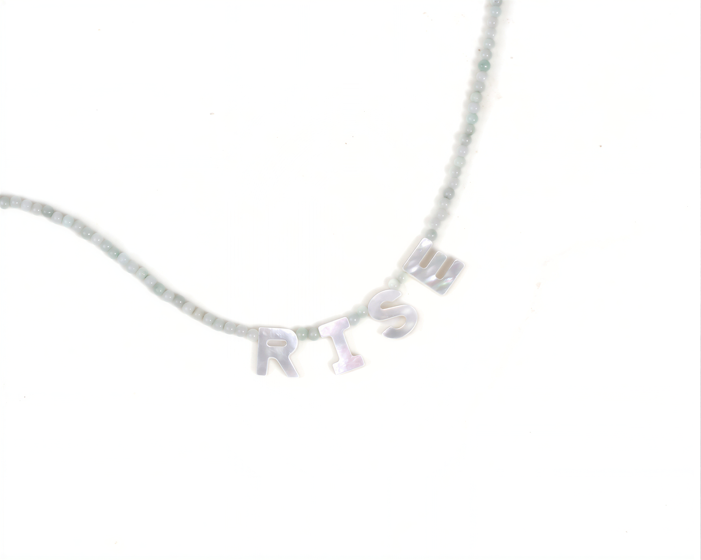 A necklace with the word 'RISK' spelled out in letters on it.