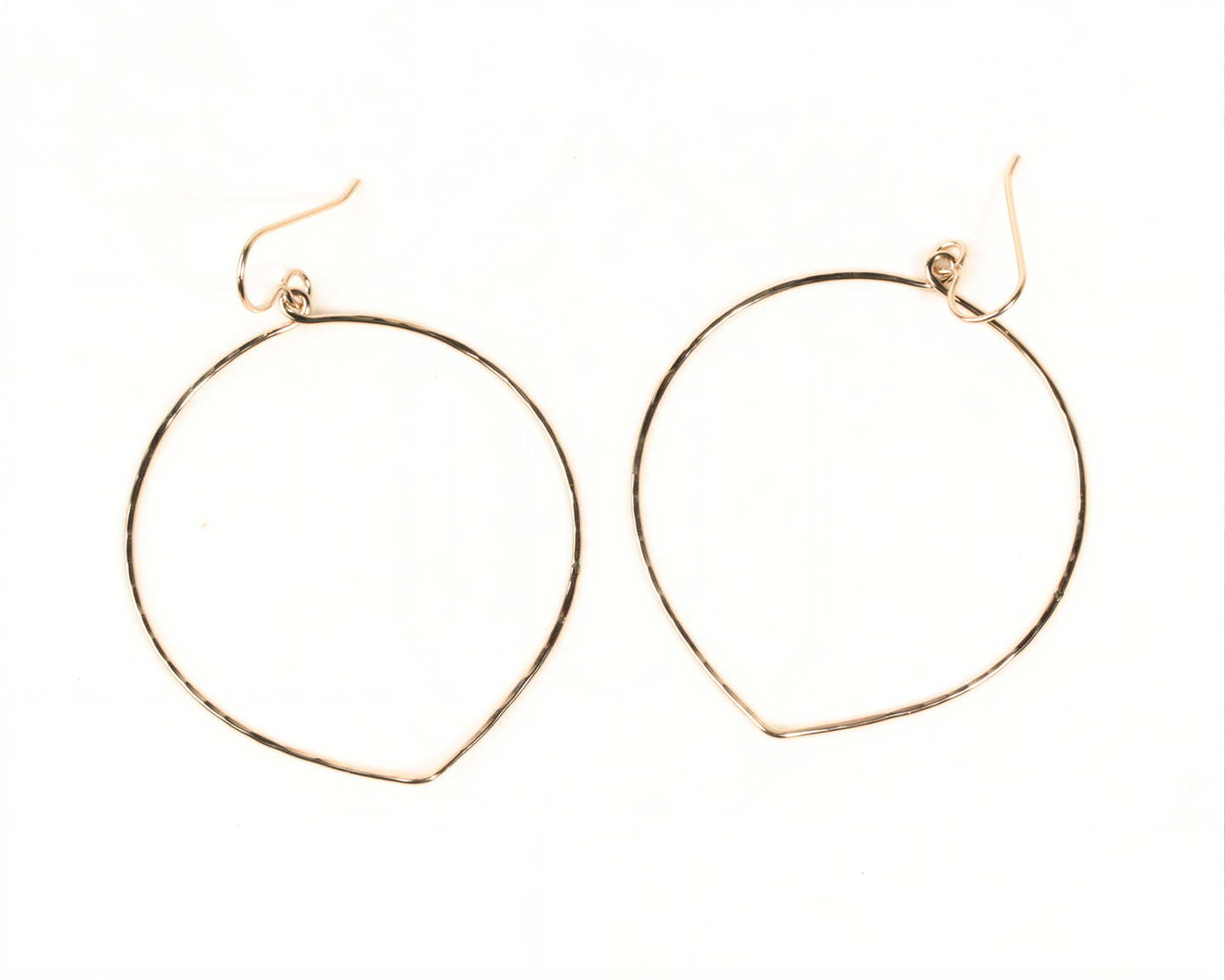 A pair of gold hoop earrings with a simple, minimalist design.