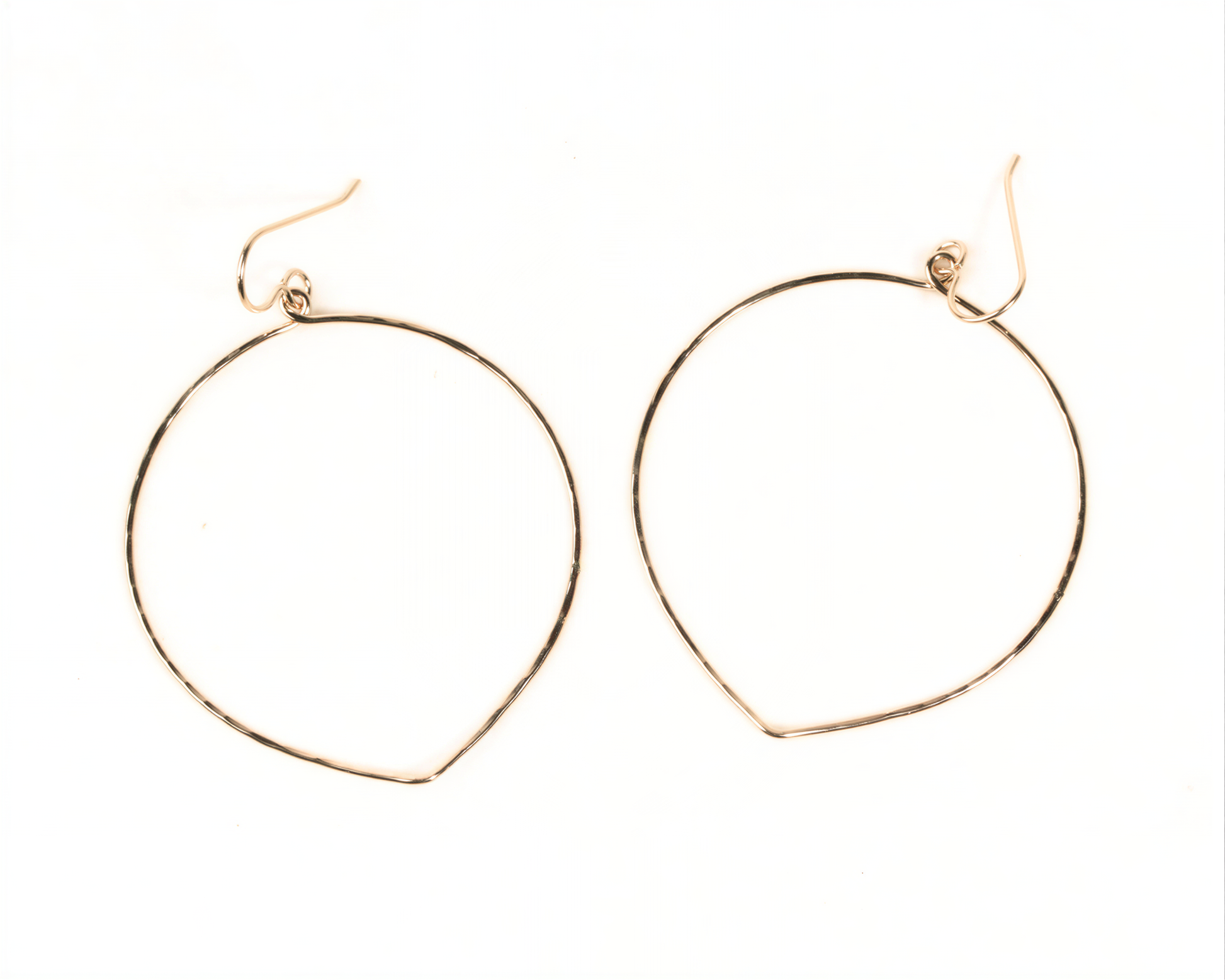 A pair of gold hoop earrings with a simple, minimalist design.