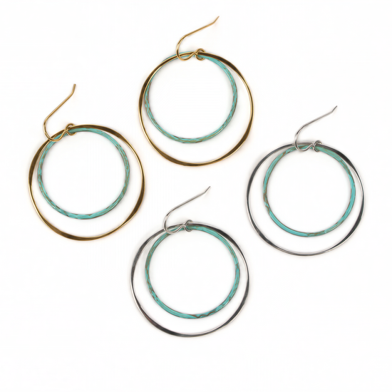 a collection of four hoop earrings, each with a unique design and color. The earrings are arranged in a row, showcasing their various styles and colors.