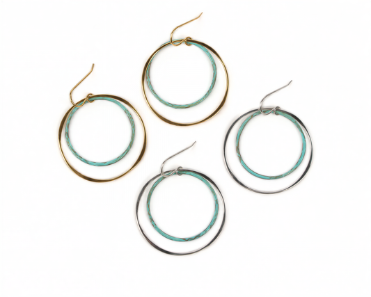 a collection of four hoop earrings, each with a unique design and color. The earrings are arranged in a row, showcasing their various styles and colors.