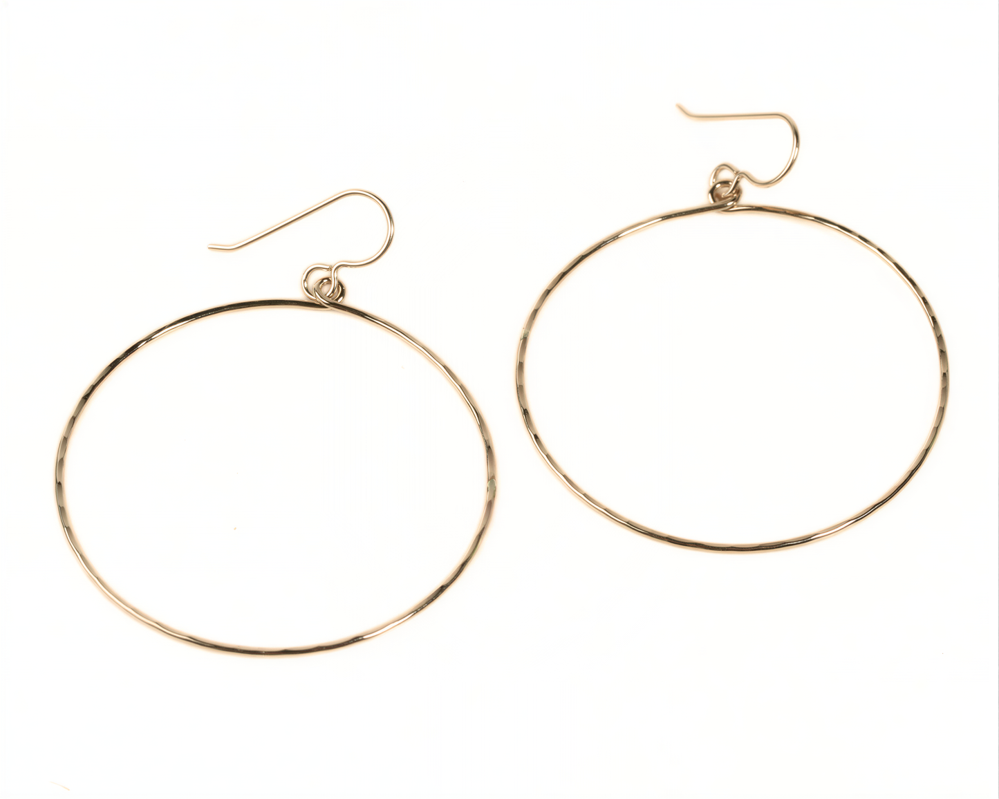 A pair of gold hoop earrings with a simple, minimalist design.