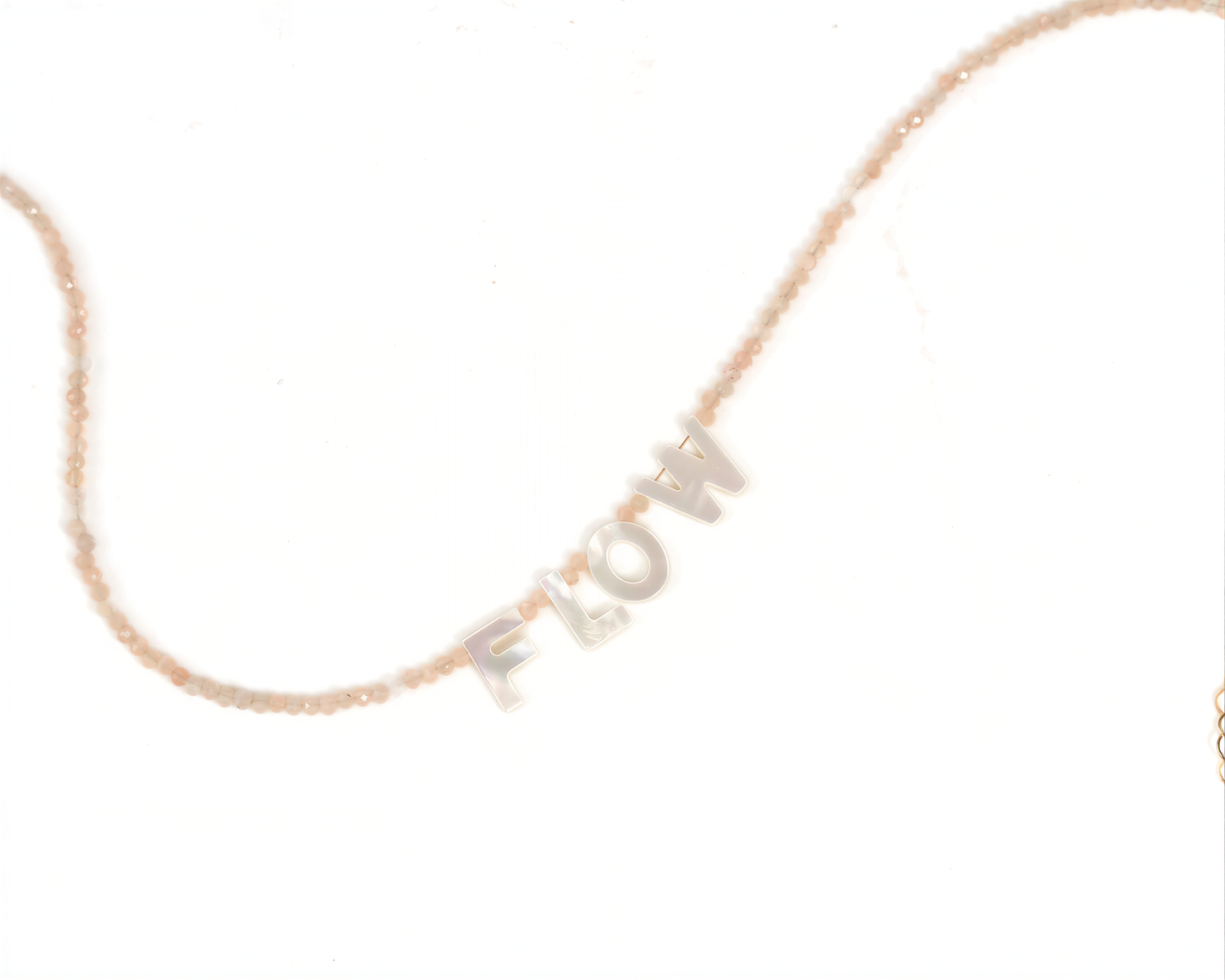 A necklace with the word "FLOW" spelled out in letters on it.