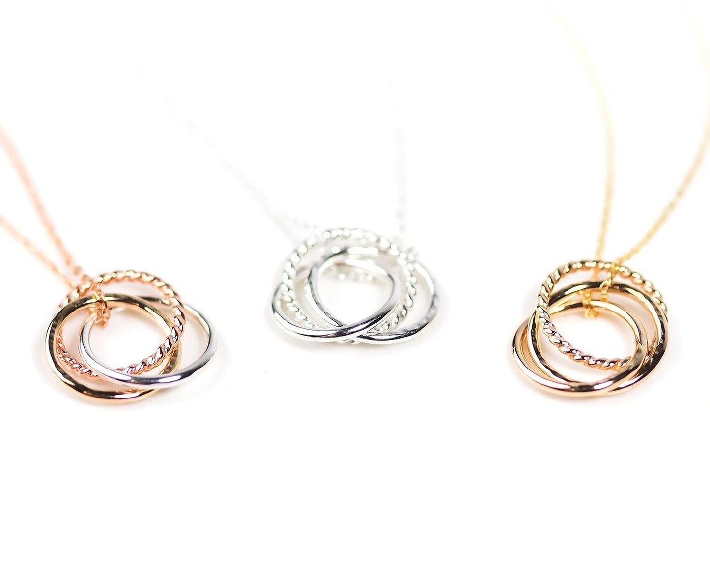 Three different types of necklaces with interlocking rings in various colors, including gold, silver, and rose gold.