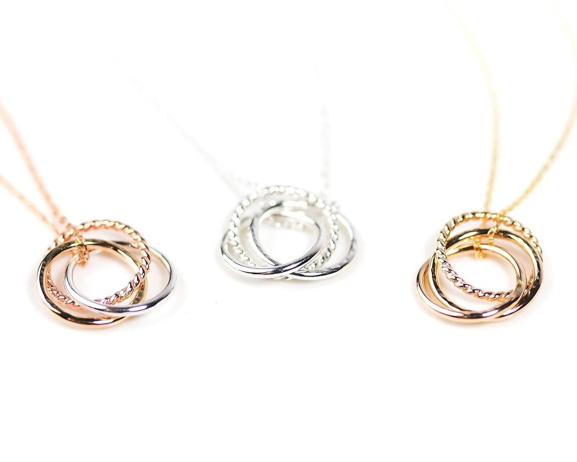 Three different types of necklaces with interlocking rings in various colors, including gold, silver, and rose gold.