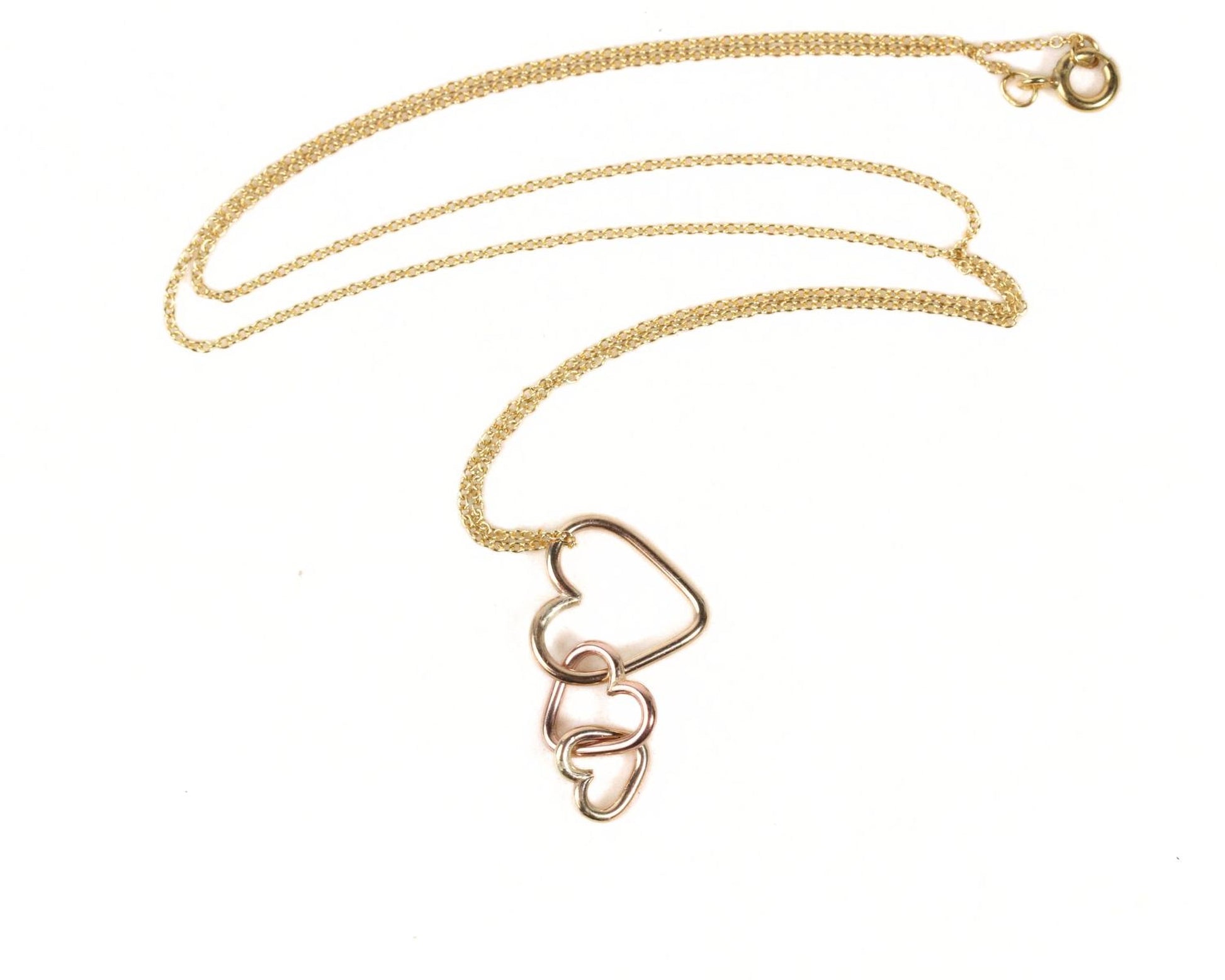 A gold necklace with a pendant featuring three interlocking heart shapes.