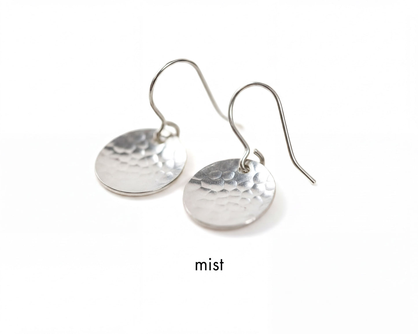 A pair of silver earrings with a textured, embossed design.