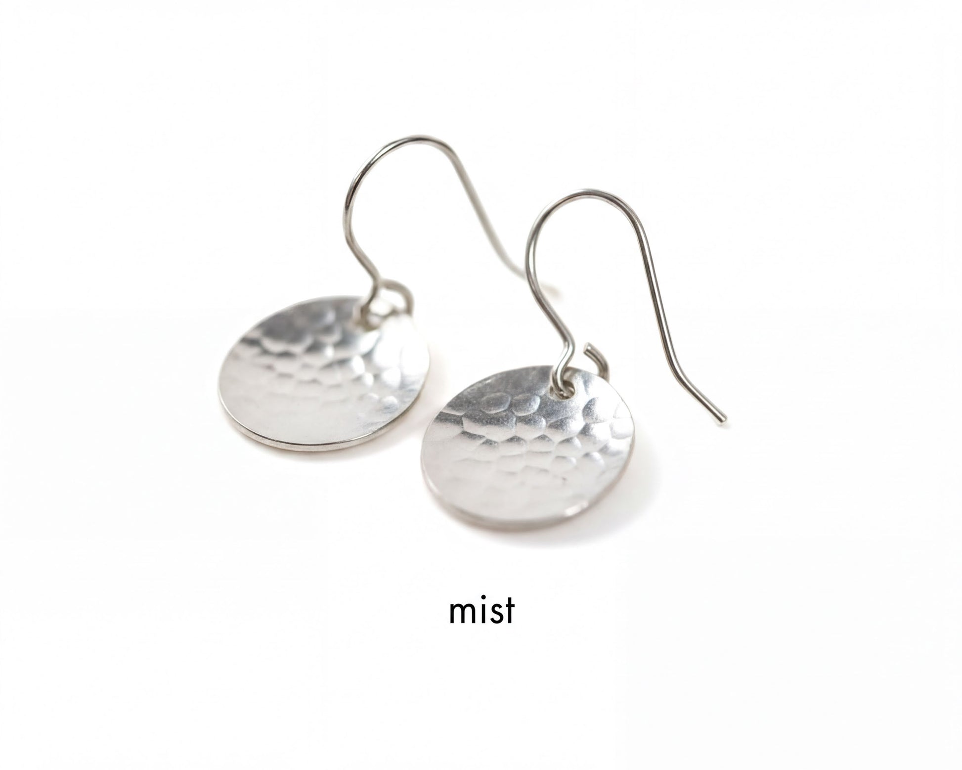 A pair of silver earrings with a textured, embossed design.