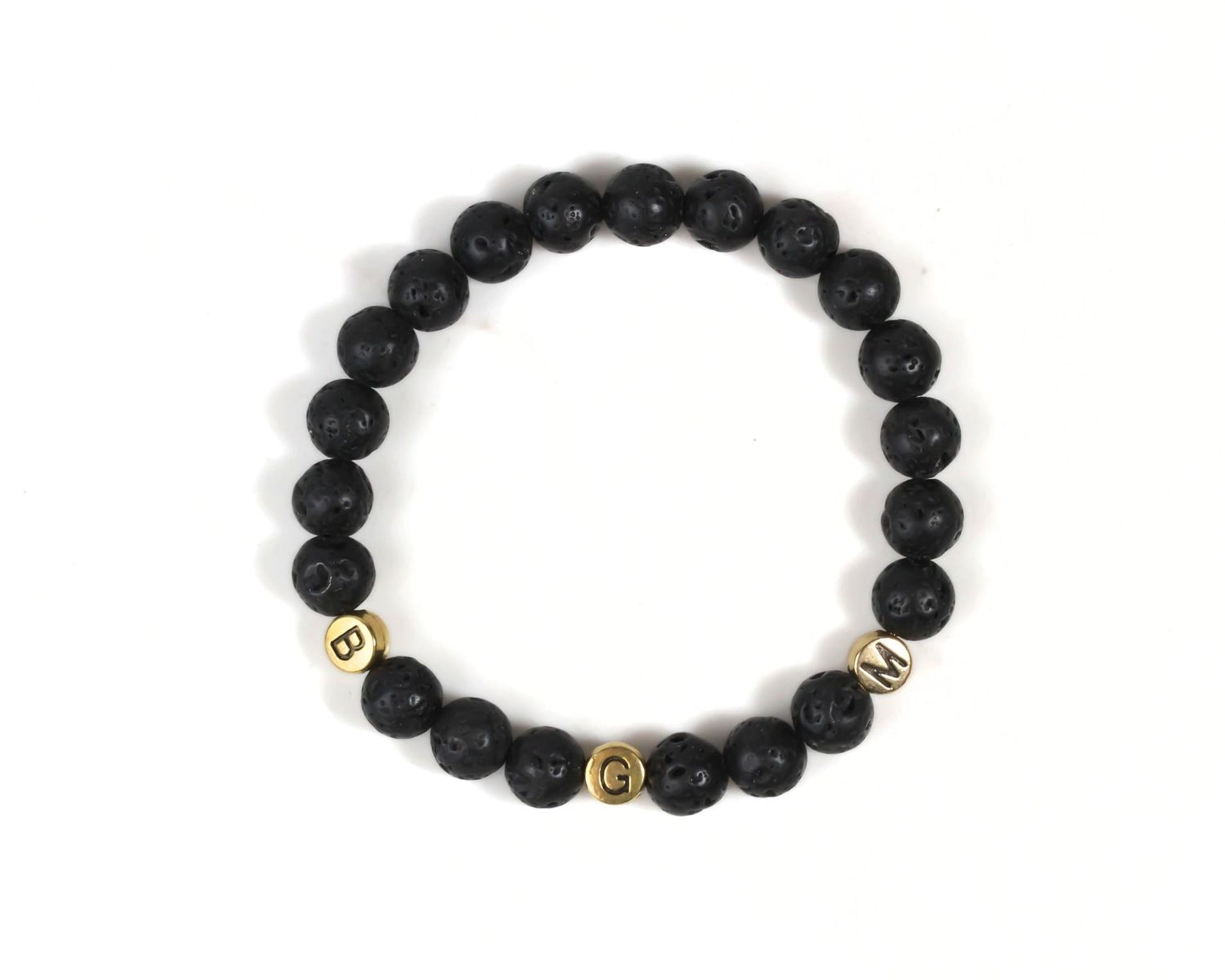 A bracelet made of black beads with gold letters spelling out the word "BGM".