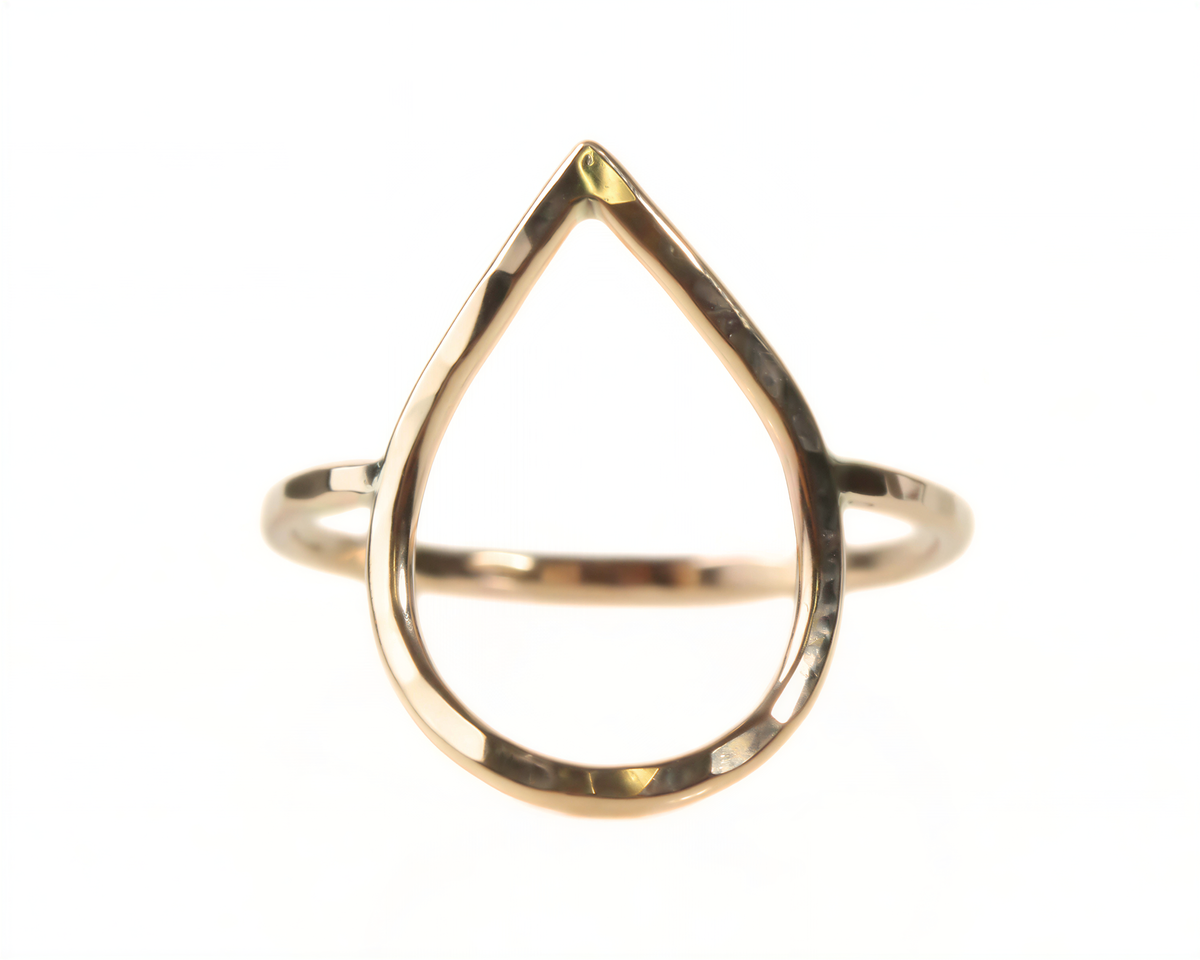 A gold ring with a unique, teardrop-shaped design.