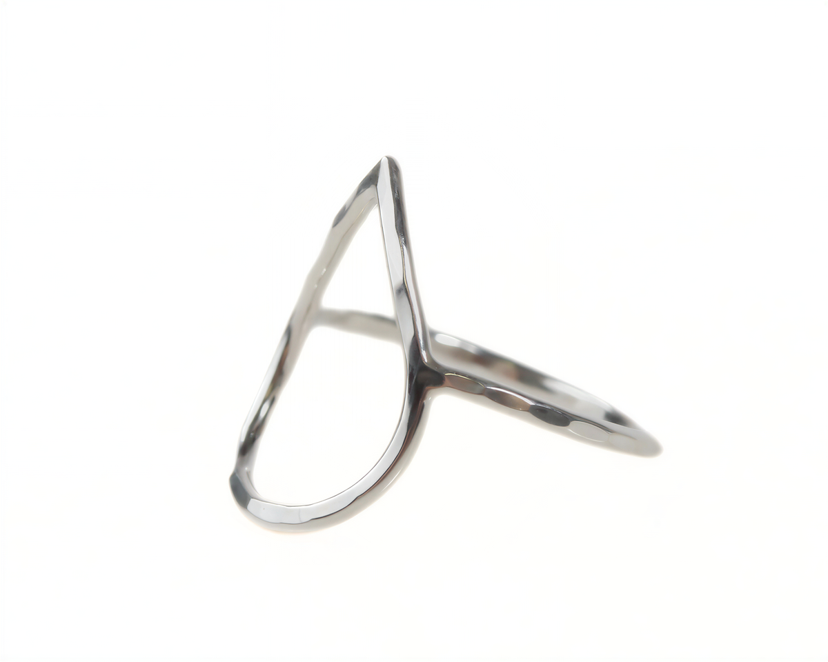 A silver ring with a unique, abstract design.