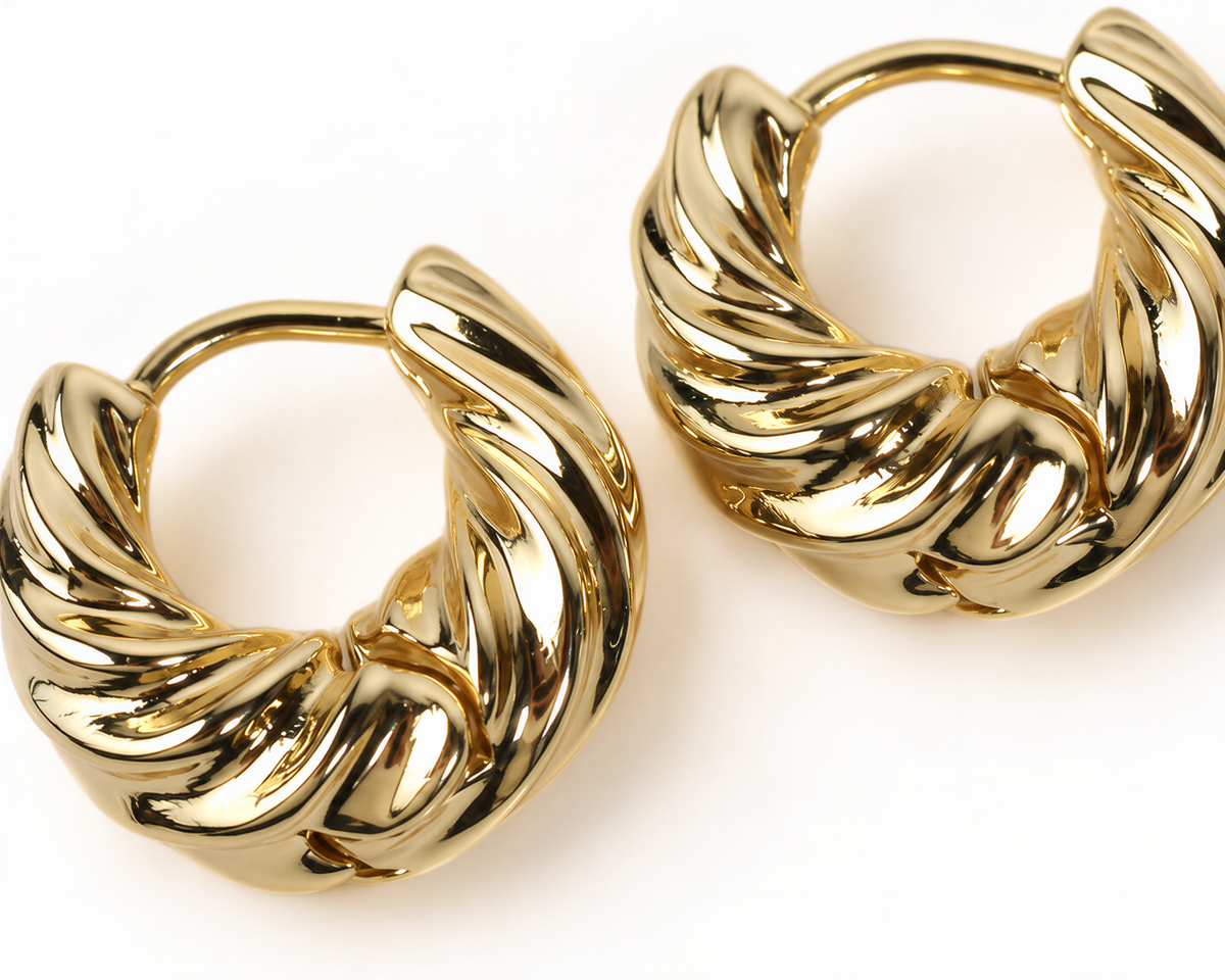 A pair of gold earrings with a twisted, braided design.
