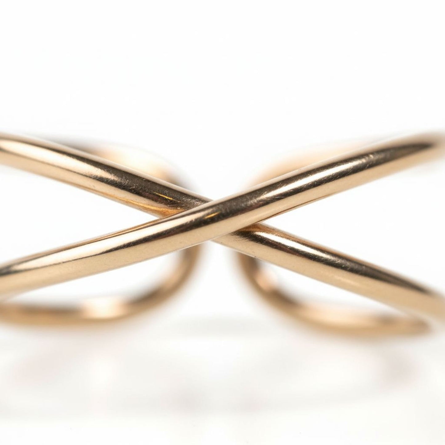 A close-up image of two gold-colored rings overlapping each other.