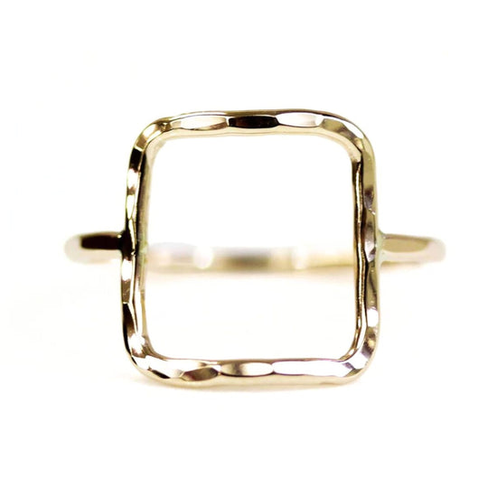 A simple, square-shaped gold ring with a textured, hand-forged design.