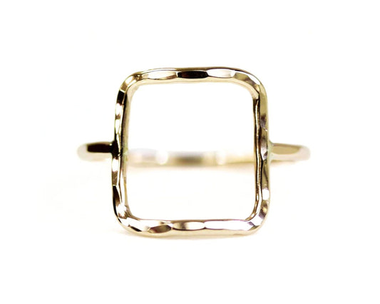 A simple, square-shaped gold ring with a textured, hand-forged design.
