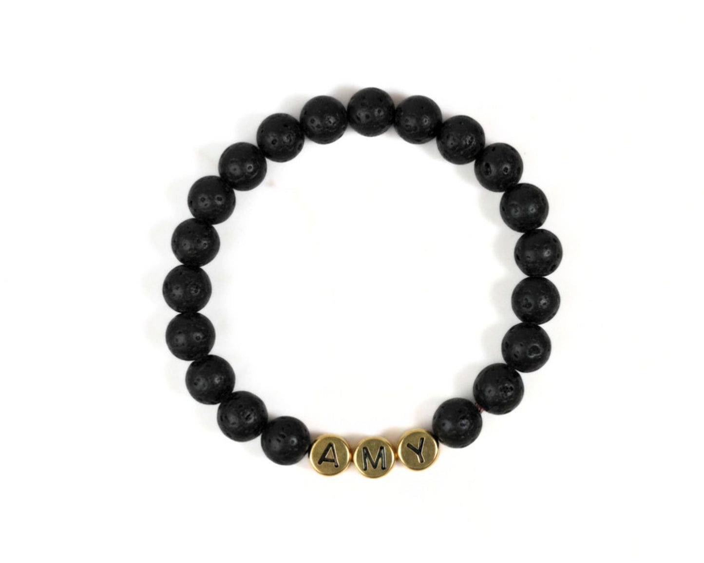 A bracelet made of black beads arranged in a circular pattern, with the letters 'A' and 'M' displayed on the beads.