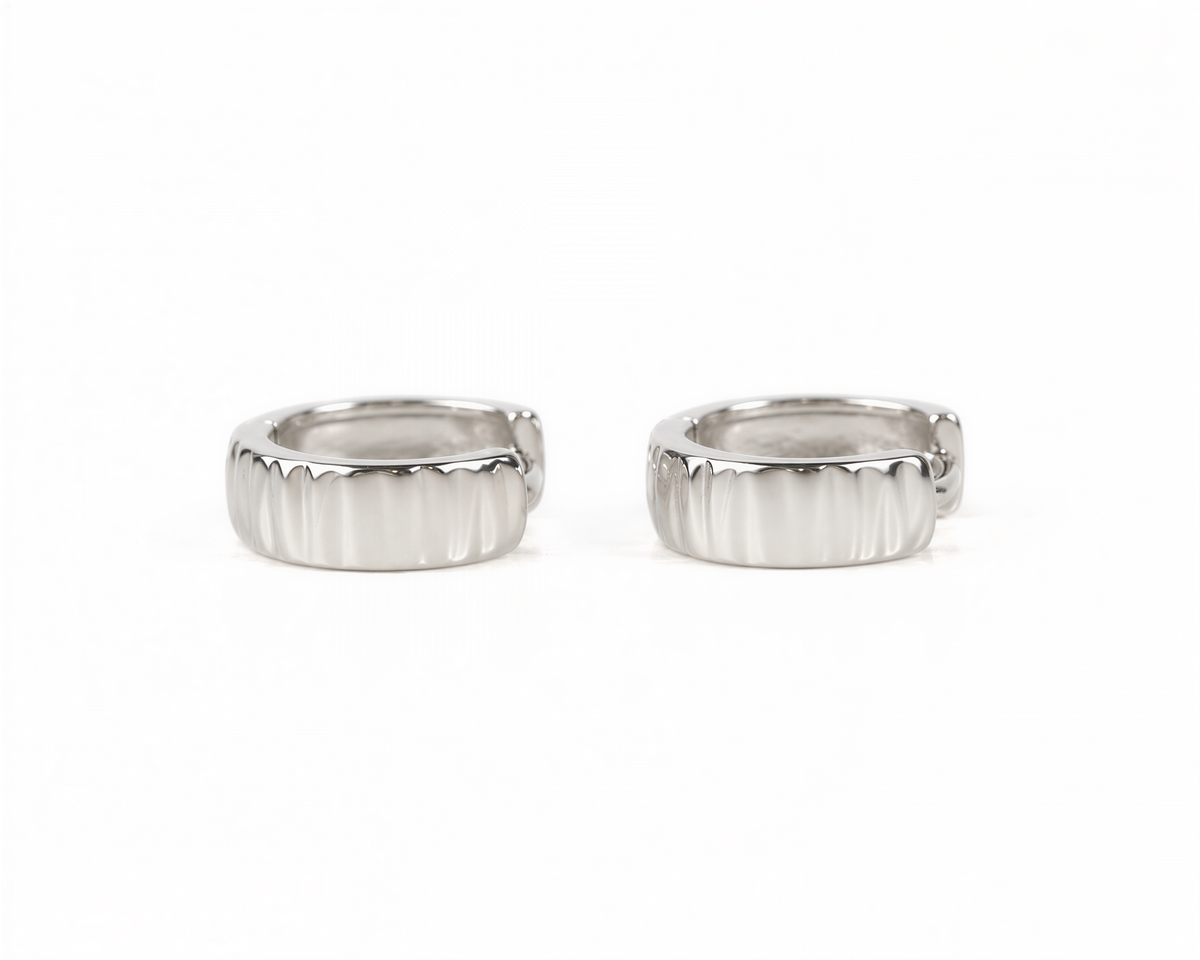 Two silver earrings with a textured design are shown against a white background.