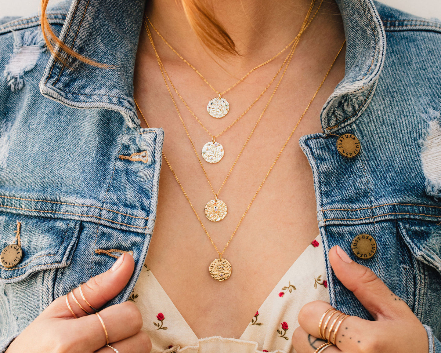 zodiac necklaces worn on model