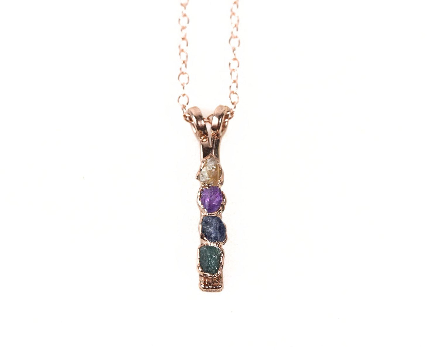 A necklace with a pendant featuring a row of colorful gemstones.