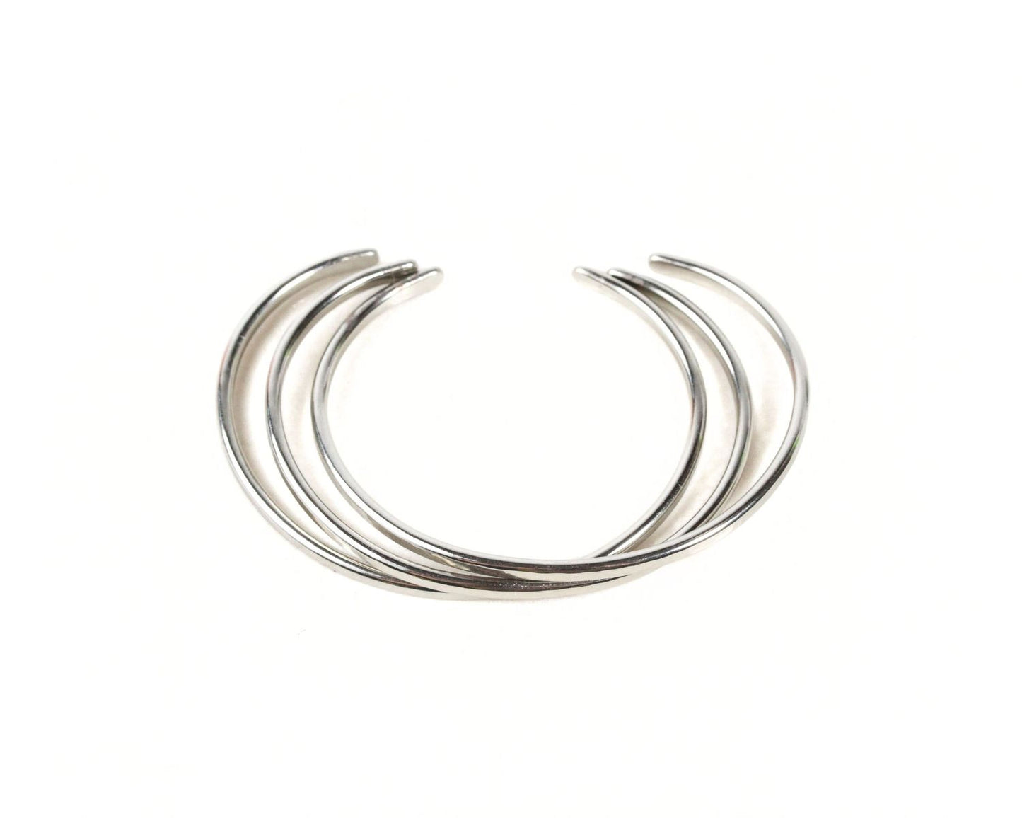 A silver-colored bracelet with multiple curved links forming a circular design.