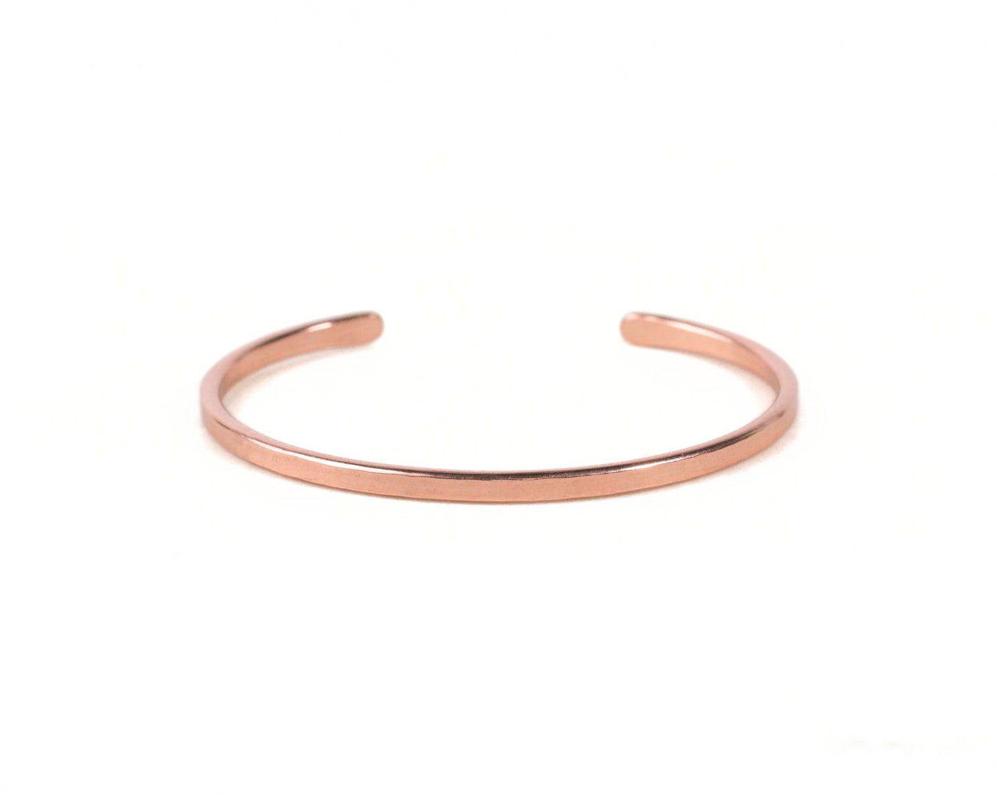 A copper-colored bracelet is shown against a white background.