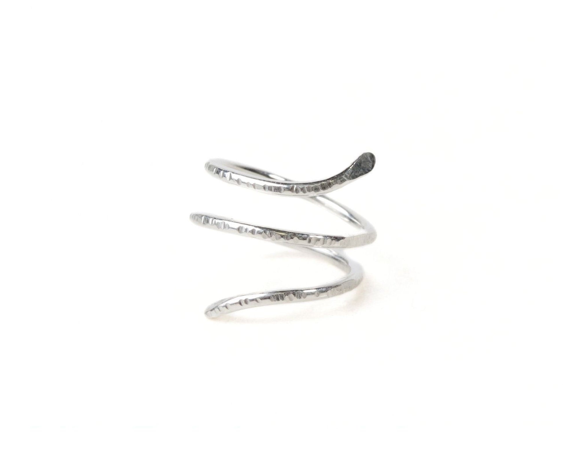 A silver spiral ring is shown against a white background.