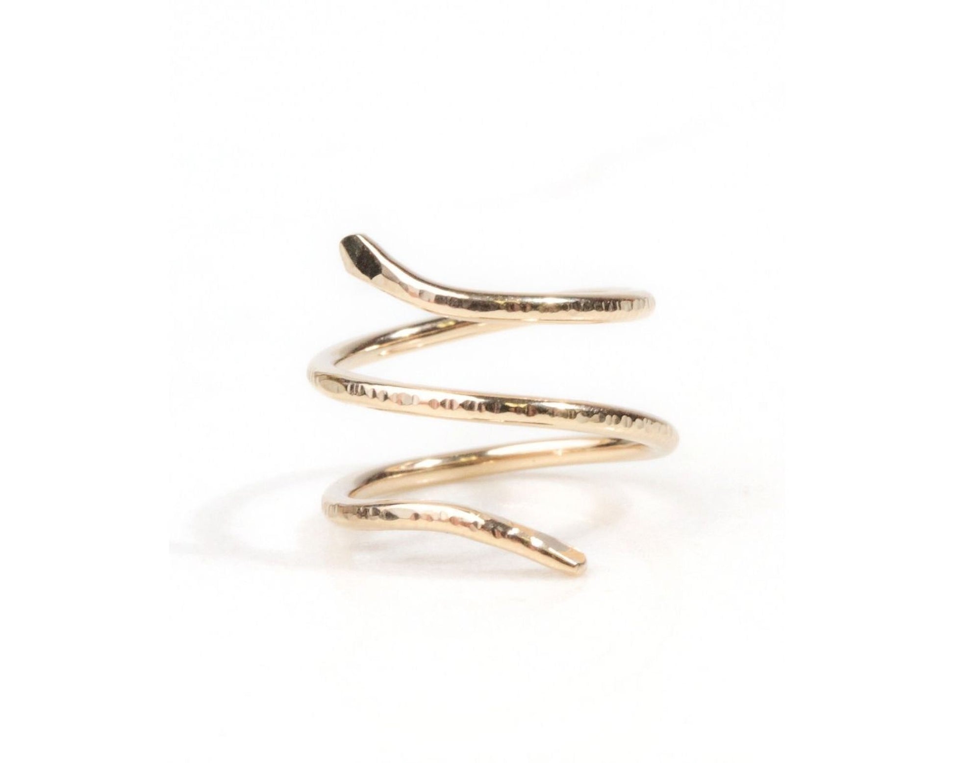A gold-colored ring in the shape of a spiral.