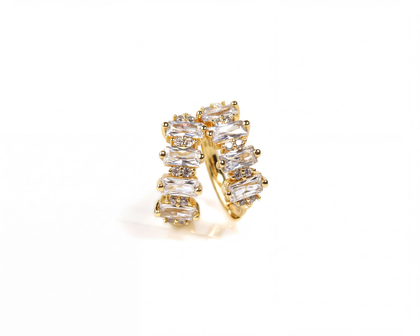 A gold-colored earring with a row of clear gemstones or diamonds set in a decorative pattern.
