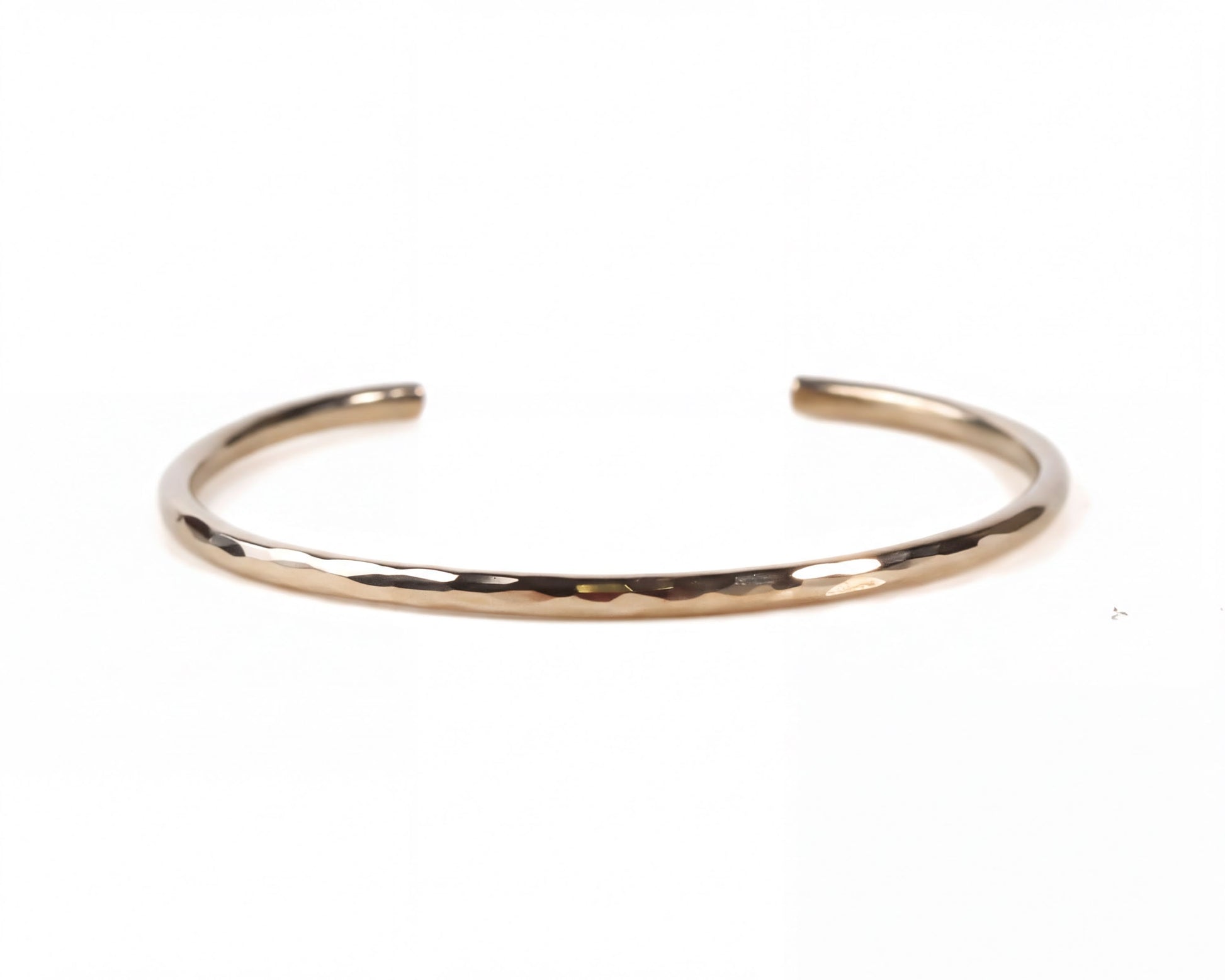 A simple, gold-colored bracelet with a smooth, shiny texture.