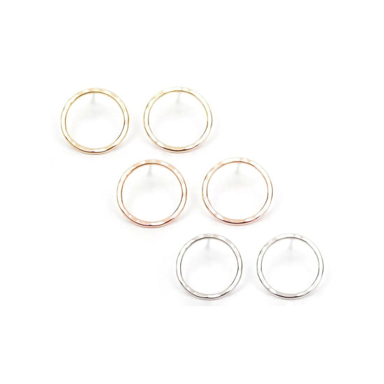 a collection of six circular earrings, each with a unique color and design, arranged in two rows of three.