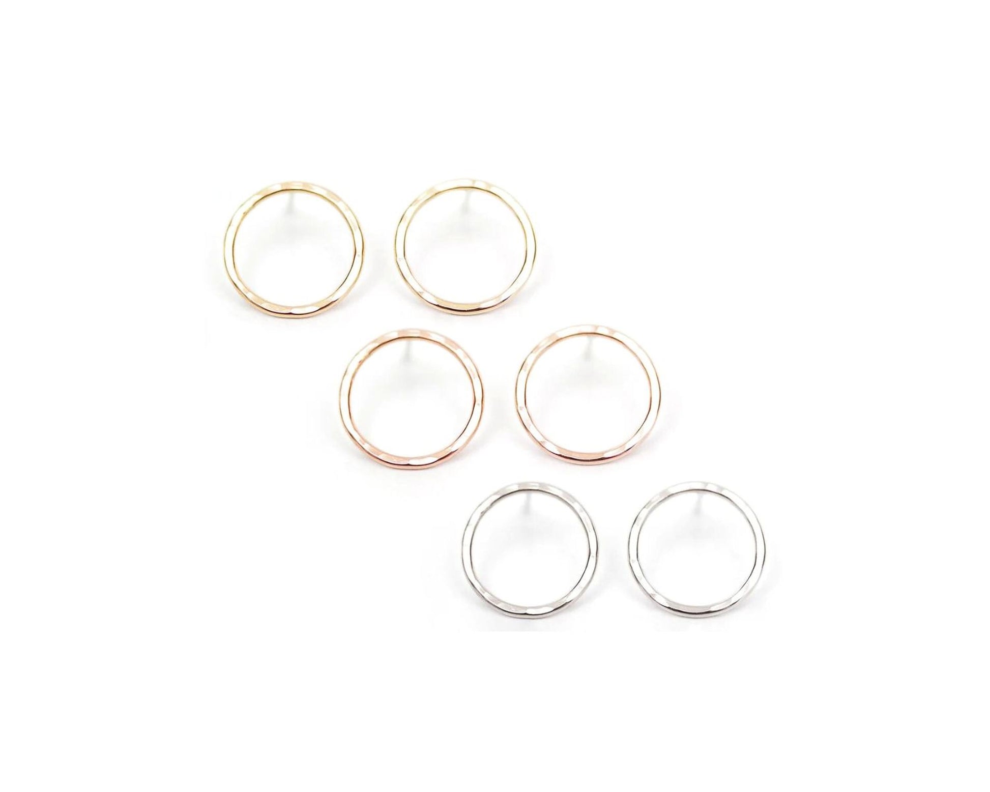 a collection of six circular earrings, each with a unique color and design, arranged in two rows of three.